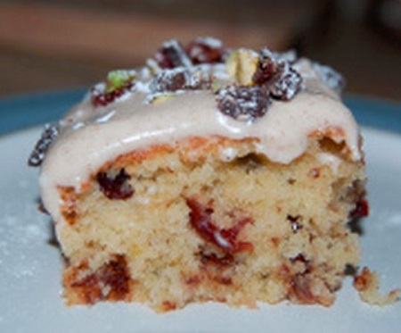 Festive Toblerone Tray Bake with Cranberries, Pistachios and a Cinnamon Cream Cheese Frosting