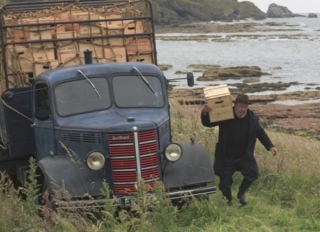 whisky van with man carrying box of whisky in Scotland