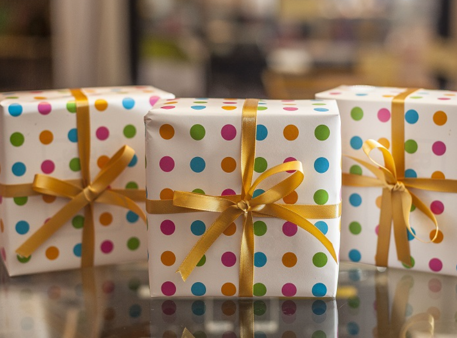 Wrapped boxes of fudge in polka dot wrapping paper and gold ribbon